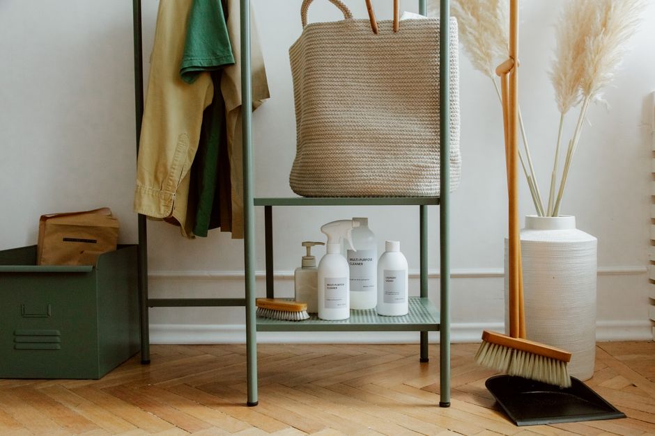 Eco-friendly cleaning products and home storage solutions in a modern, minimalist interior.